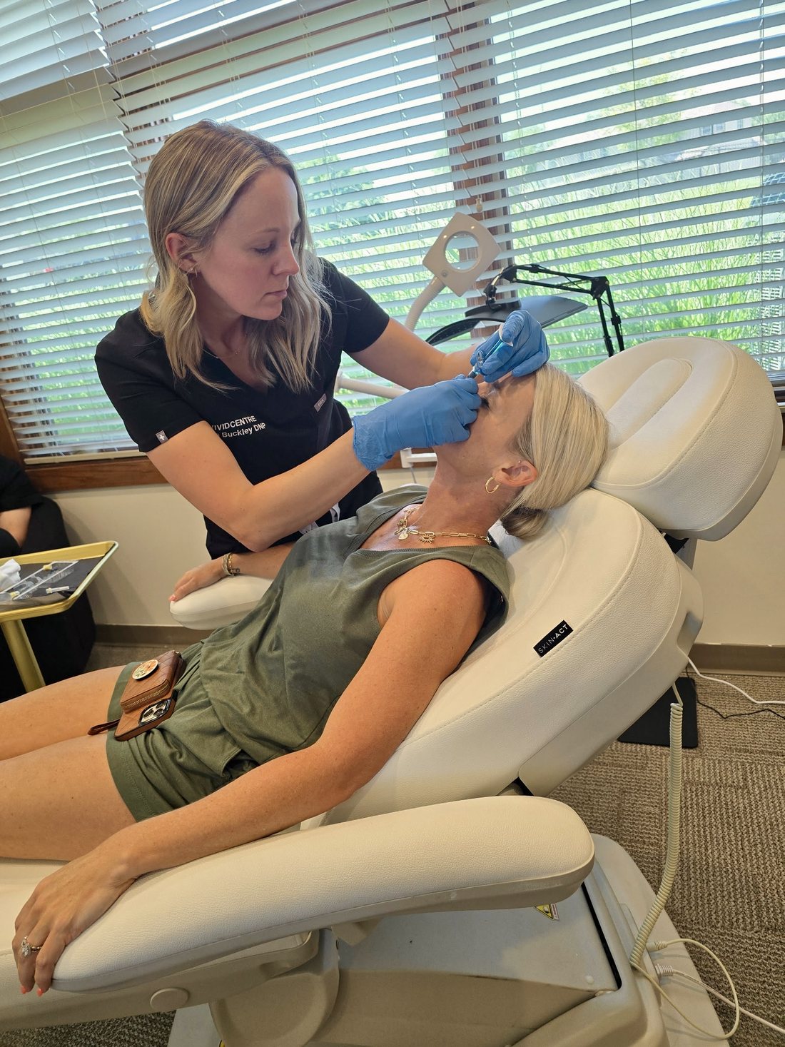Sara Buckley administering a precise forehead wrinkle treatment